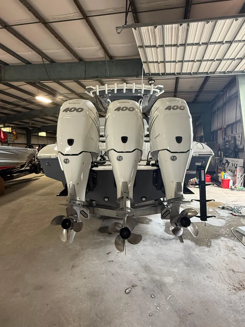 Slide: The Image of 2023 Fountain 34 CC boat with triple 400 horsepower engines in a warehouse. - 22