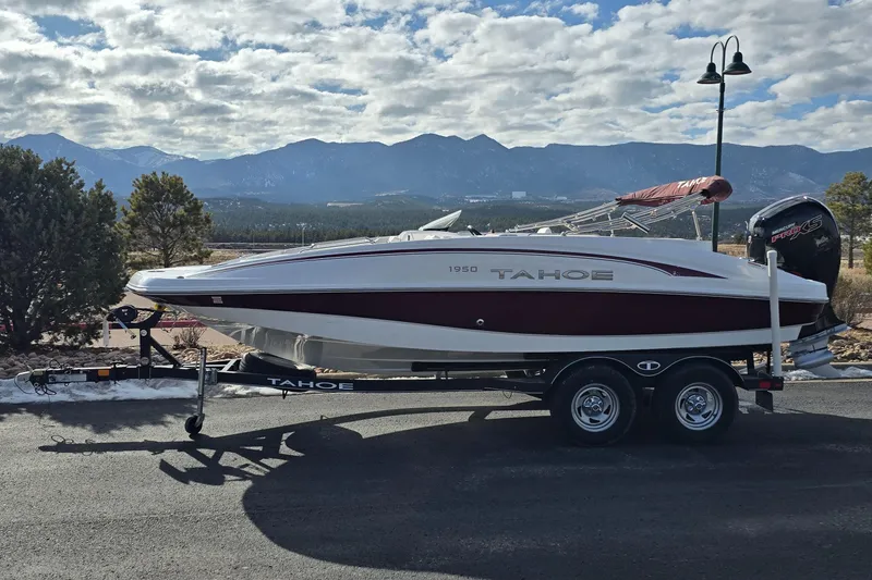 Slide: The Image of Tahoe 1950 boat on trailer, 2020 model, parked with mountain backdrop. - 1
