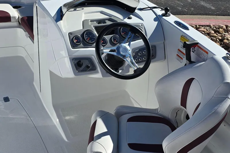 Slide: The Image of Steering console of a 2020 Tahoe 1950 boat with gauges and white seating. - 5