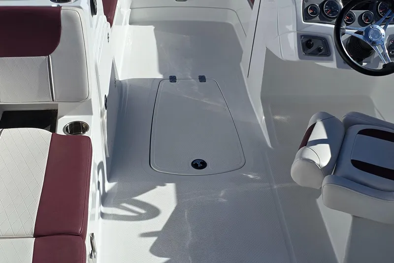 Slide: The Image of Interior of a 2020 Tahoe 1950 boat with white and maroon seating. - 6