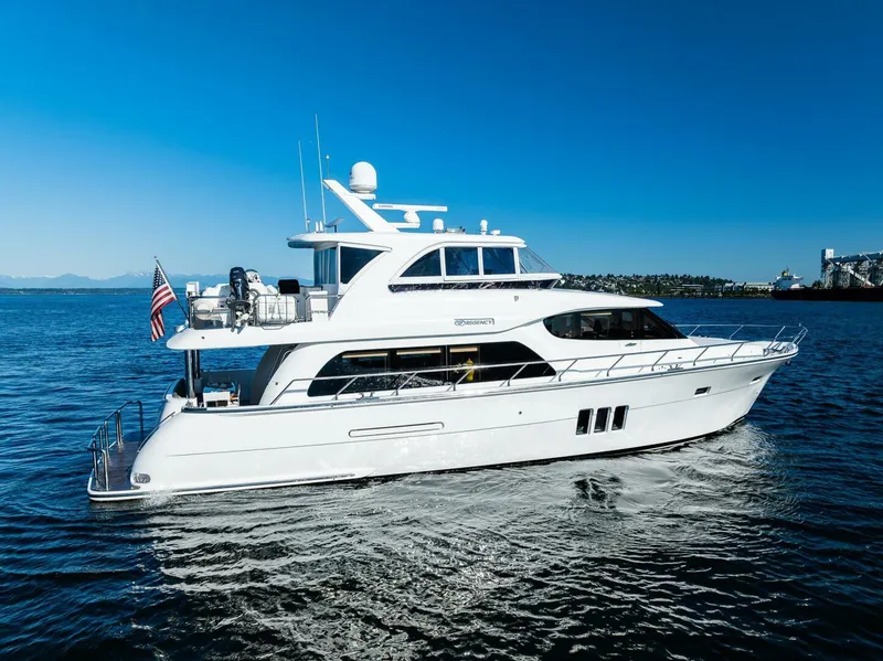 Slide: The Image of 2017 Regency P65 yacht cruising on open water under clear blue skies. - 0