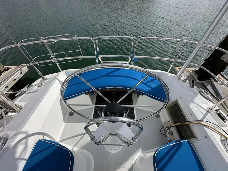 Slide: The Image of Cockpit of 1987 Hunter Legend 45 sailboat with blue seating and steering wheel. - 18