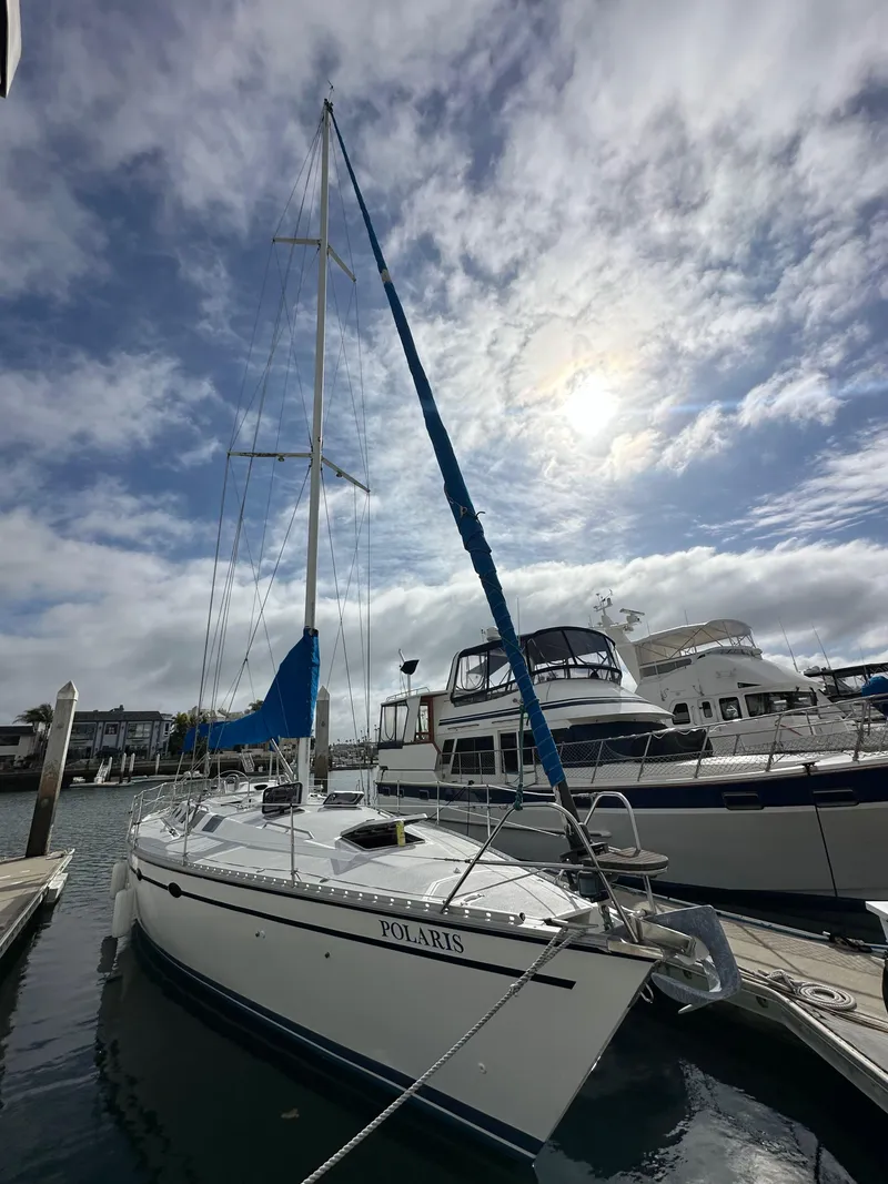 Slide: The Image of 1987 Hunter Legend 45 sailboat docked under a cloudy sky. - 2