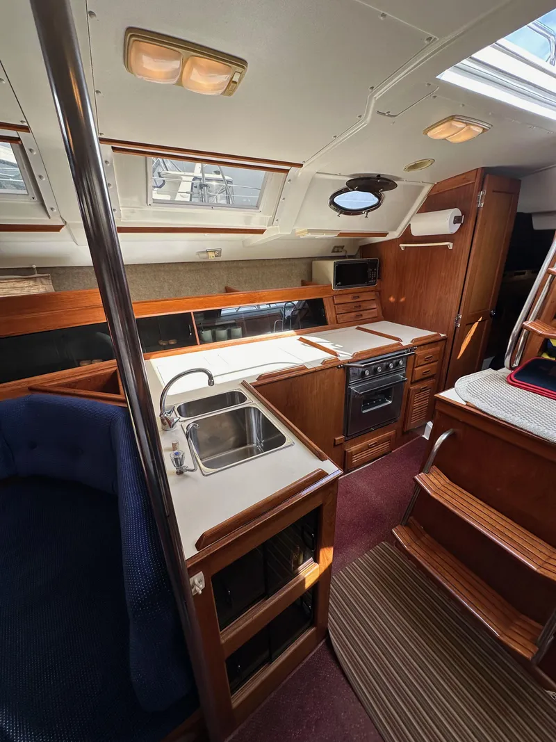 Slide: The Image of Interior of 1987 Hunter Legend 45 sailboat with kitchen and seating area. - 28