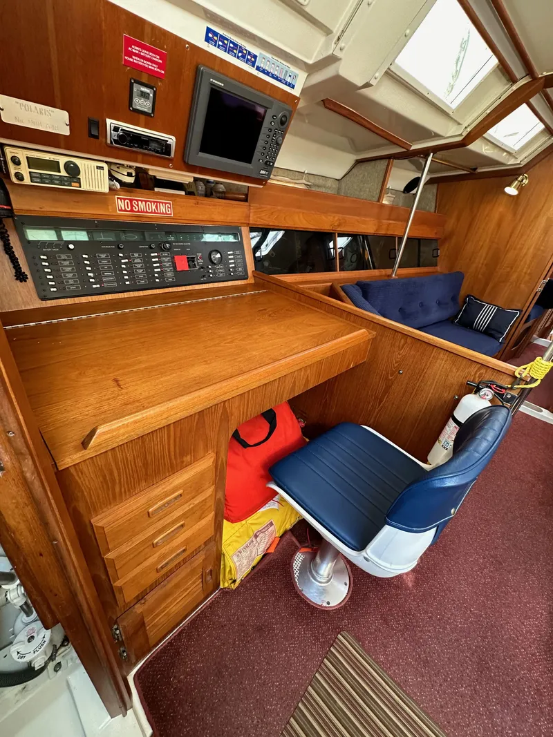 Slide: The Image of 1987 Hunter Legend 45 yacht interior with navigation station and seating area. - 40