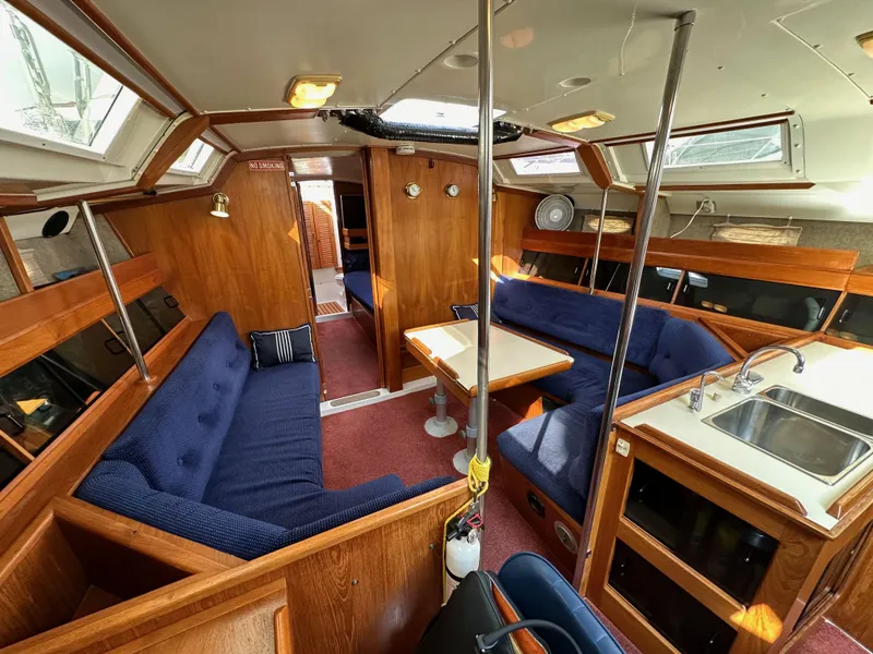 Slide: The Image of Interior of 1987 Hunter Legend 45 sailboat with wood finish and blue seating. - 43