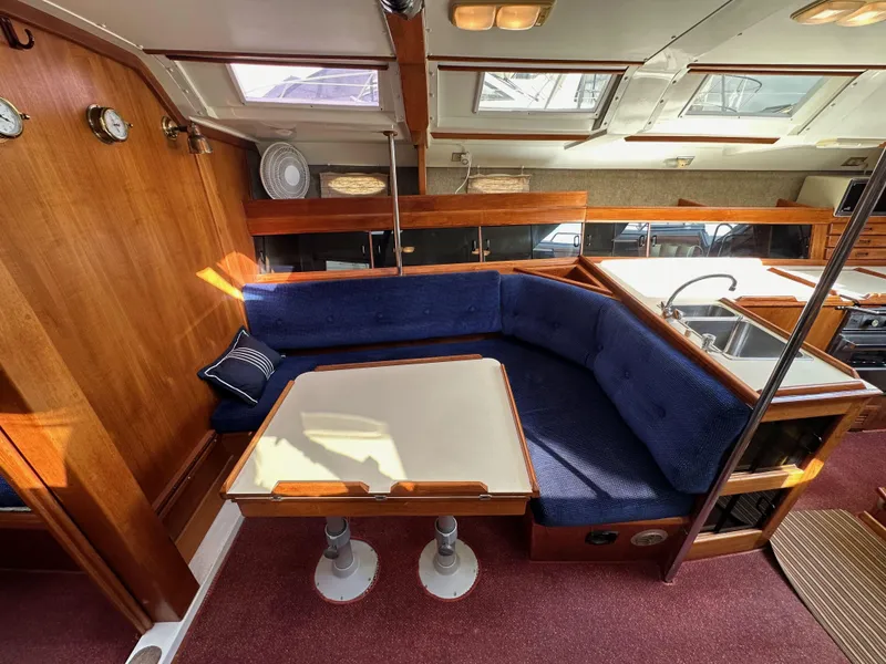 Slide: The Image of Interior of 1987 Hunter Legend 45 yacht with blue seating and wooden accents. - 44