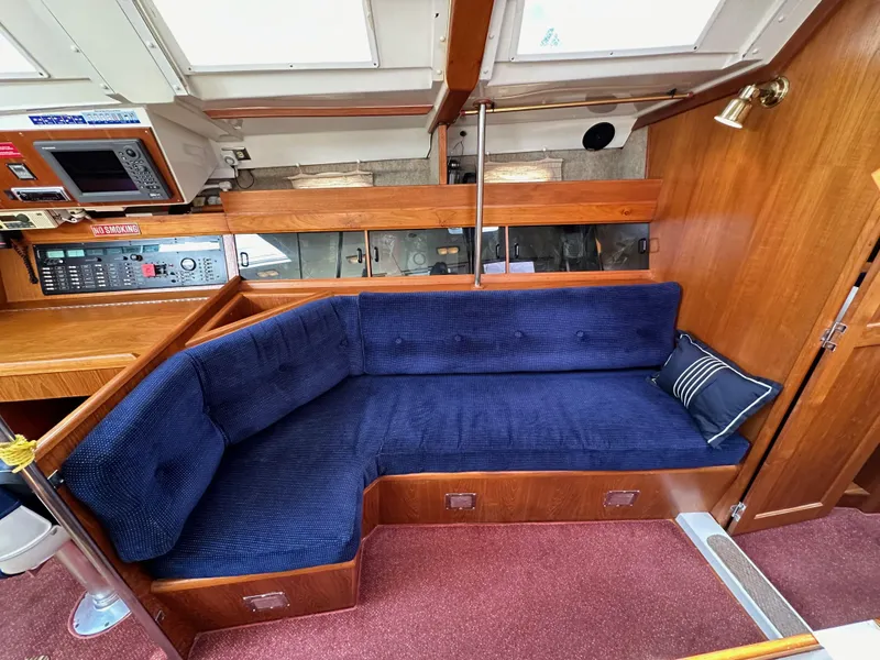 Slide: The Image of Interior of 1987 Hunter Legend 45 yacht with blue cushioned seating and wooden paneling. - 45
