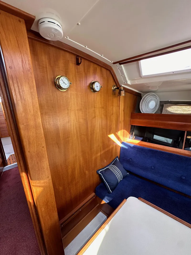 Slide: The Image of Interior of 1987 Hunter Legend 45 yacht with wooden paneling and blue seating. - 46