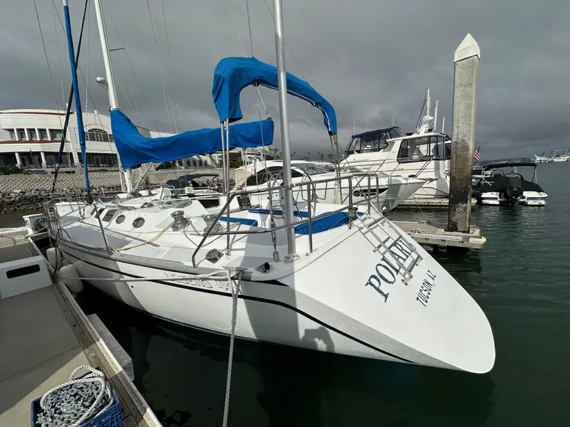 Slide: The Image of 1987 Hunter Legend 45 sailboat docked at marina with blue sail covers. - 9