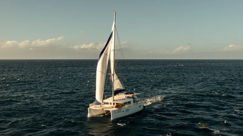 Slide: The Image of Sailing Lagoon 400 catamaran from 2012 on open sea under clear skies. - 0