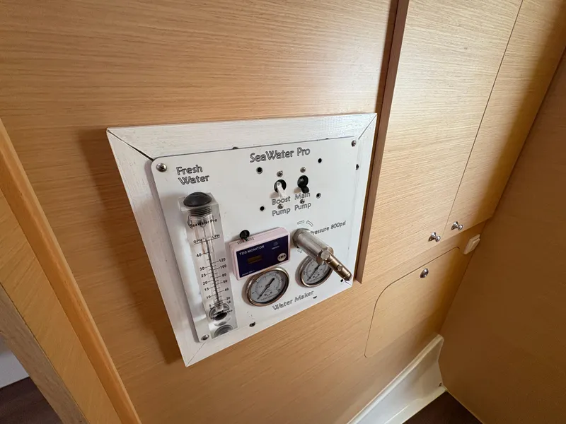 Slide: The Image of Control panel on a 2012 Lagoon 400 yacht, featuring water management gauges and switches. - 11