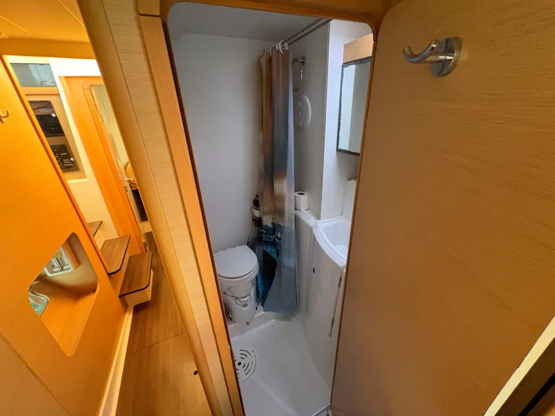 Slide: The Image of Compact bathroom in a 2012 Lagoon 400 catamaran, featuring a shower and toilet. - 17