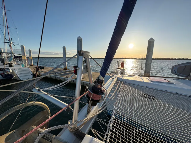 Slide: The Image of Lagoon 400 catamaran docked at sunset, 2012 model, with calm waters and clear sky. - 32