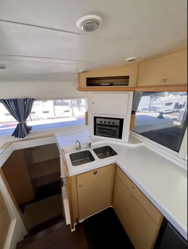 Slide: The Image of 2012 Lagoon 400 yacht kitchen with dual sinks, oven, and ample counter space. - 49