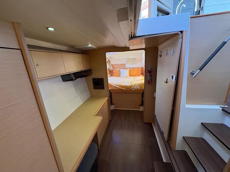 Slide: The Image of Interior of 2012 Lagoon 400 catamaran featuring a cozy cabin and modern design. - 5