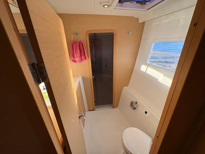 Slide: The Image of Spacious bathroom in 2012 Lagoon 400 yacht with modern fixtures and ocean view window. - 8