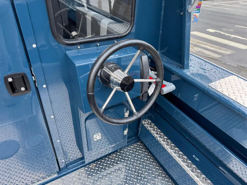 Slide: The Image of 2025 Hewescraft 220 Ocean Pro steering wheel and dashboard, featuring a sleek blue design. - 10