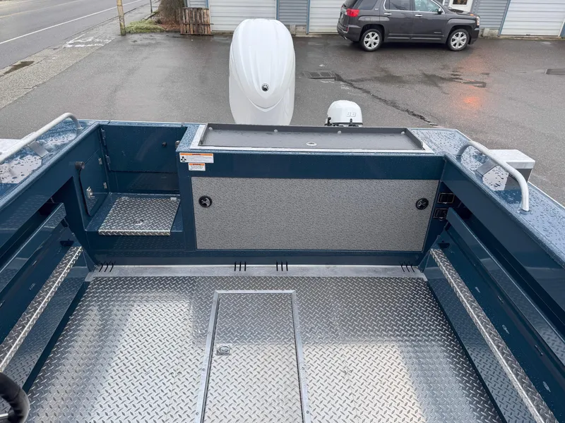 Slide: The Image of 2025 Hewescraft 220 Ocean Pro boat interior with aluminum flooring and outboard motor. - 11