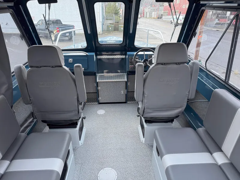Slide: The Image of Interior of 2025 Hewescraft 220 Ocean Pro boat with gray seating and steering console. - 5