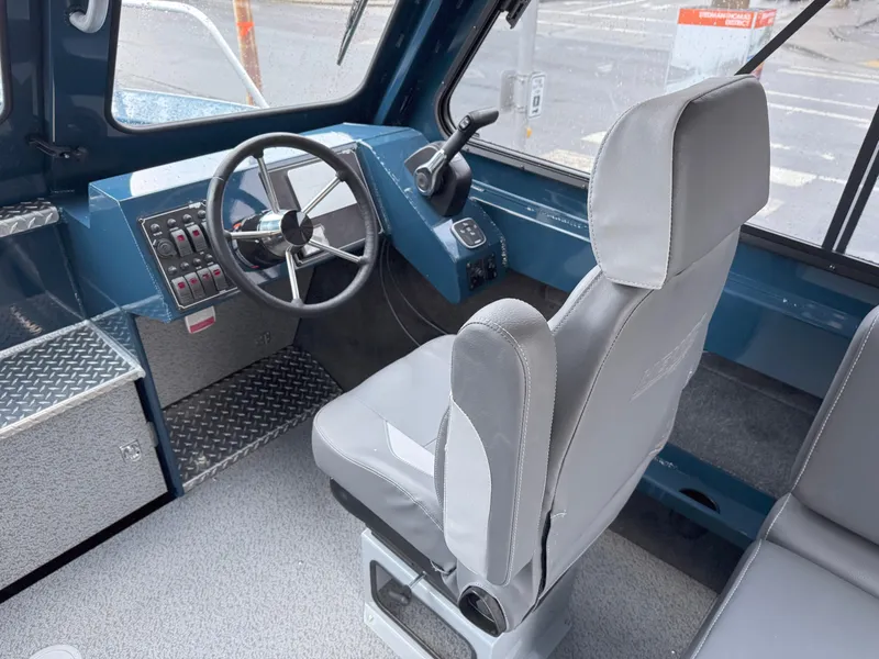 Slide: The Image of 2025 Hewescraft 220 Ocean Pro boat interior with steering wheel and captain's seat. - 6