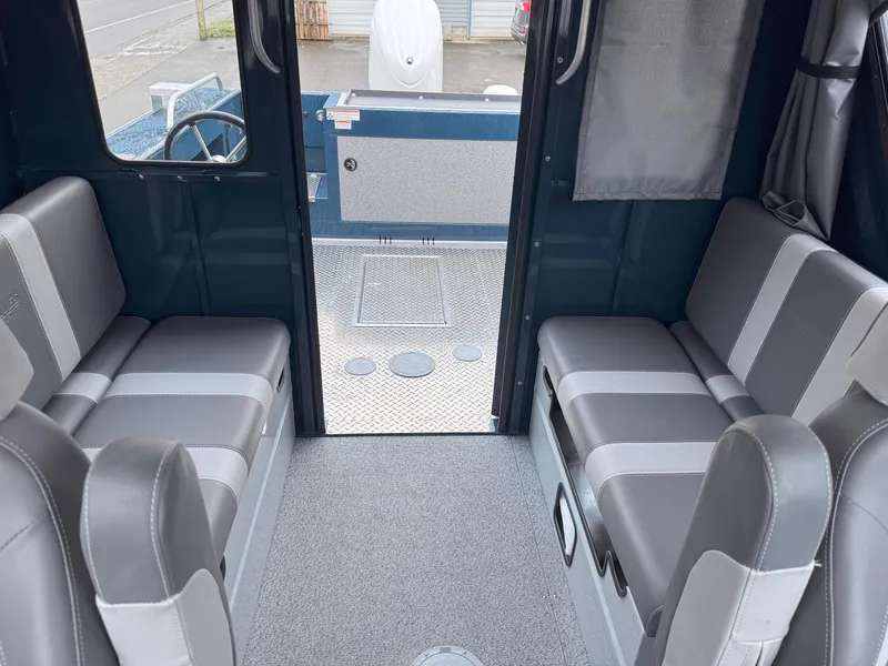 Slide: The Image of 2025 Hewescraft 220 Ocean Pro interior with gray seating and spacious layout. - 8