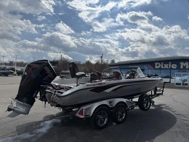 Slide: The Image of 2020 Ranger 621FS boat on trailer under cloudy sky in parking lot. - 10
