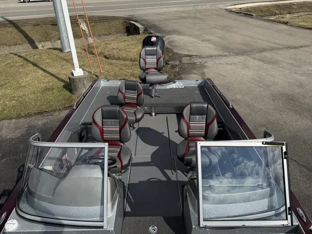 Slide: The Image of 2020 Ranger 621FS boat with seating, windshield, and open deck, parked on pavement. - 9