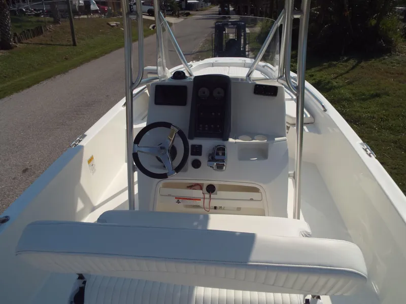 Slide: The Image of 2013 Boston Whaler 230 Dauntless boat interior with steering console and seating. - 2