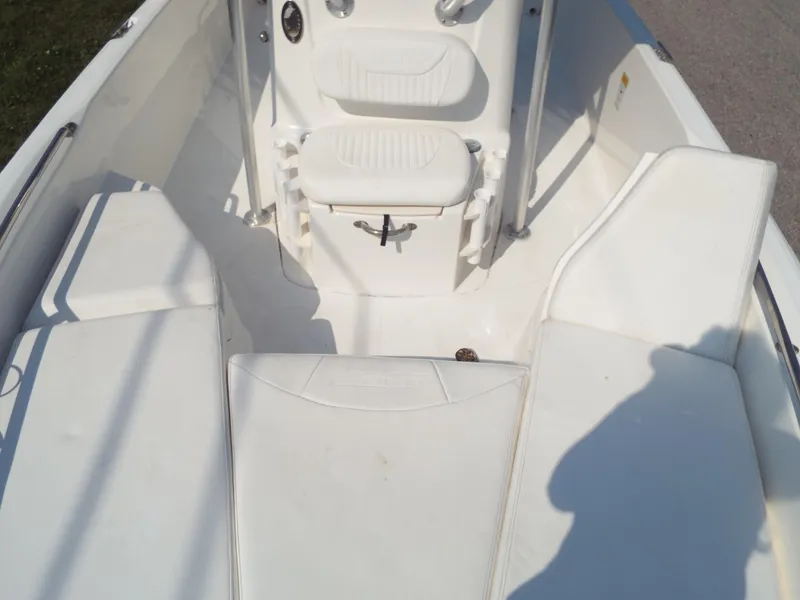 Slide: The Image of 2013 Boston Whaler 230 Dauntless boat interior with white seating and console. - 4
