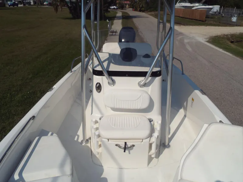 Slide: The Image of 2013 Boston Whaler 230 Dauntless boat interior with seating and console. - 5