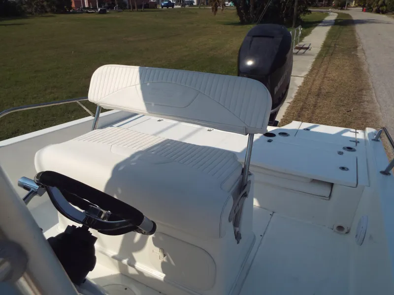 Slide: The Image of 2013 Boston Whaler 230 Dauntless boat interior with steering wheel and seating. - 6