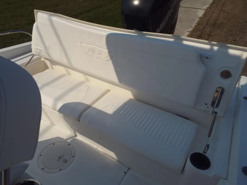 Slide: The Image of Boston Whaler 230 Dauntless 2013 boat seating area with white cushioned seats. - 7