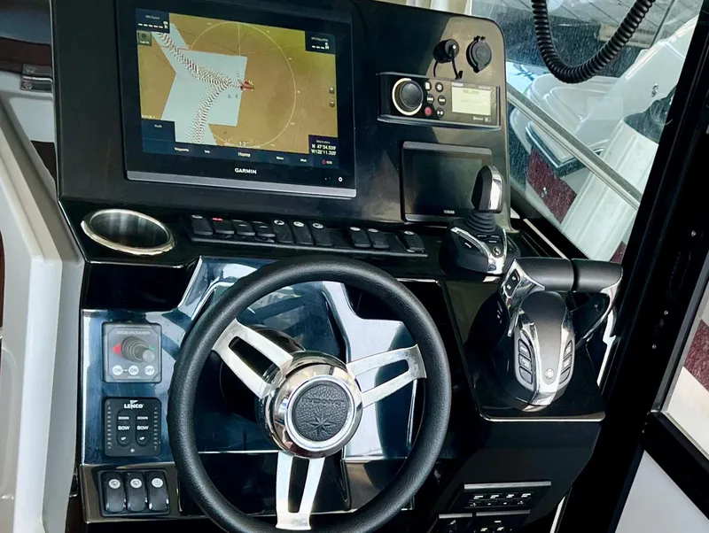 Slide: The Image of 2022 Jeanneau NC 895 Sport helm with navigation display and controls. - 16