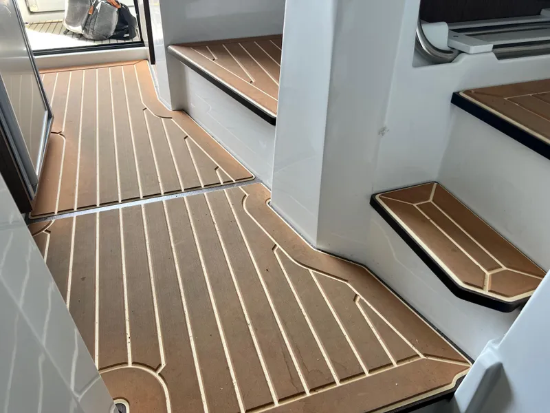 Slide: The Image of 2022 Jeanneau NC 895 Sport interior with teak flooring and modern design. - 17