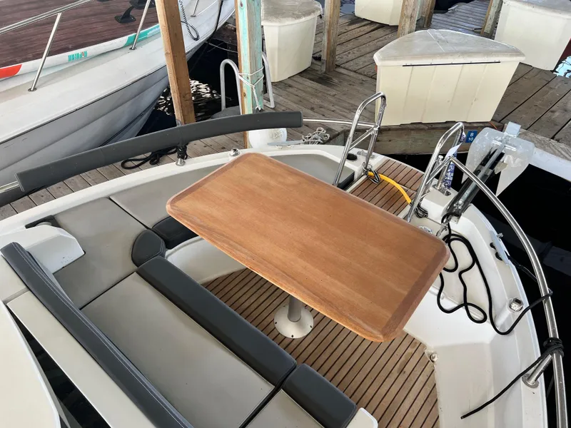 Slide: The Image of 2022 Jeanneau NC 895 Sport boat with wooden table and seating on deck. - 4