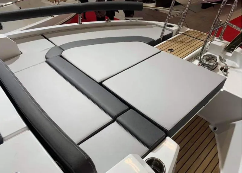 Slide: The Image of 2022 Jeanneau NC 895 Sport boat with cushioned seating and teak deck. - 5
