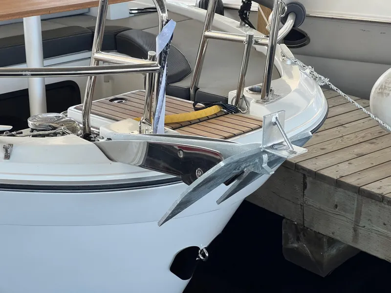 Slide: The Image of 2022 Jeanneau NC 895 Sport boat anchored at a wooden dock. - 6