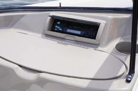 Slide: The Image of 2004 Bayliner 195 Classic boat dashboard with stereo system and cup holder. - 15