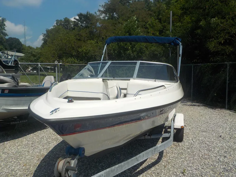 Slide: The Image of 2004 Bayliner International 195 Classic boat on trailer, parked outdoors. - 16