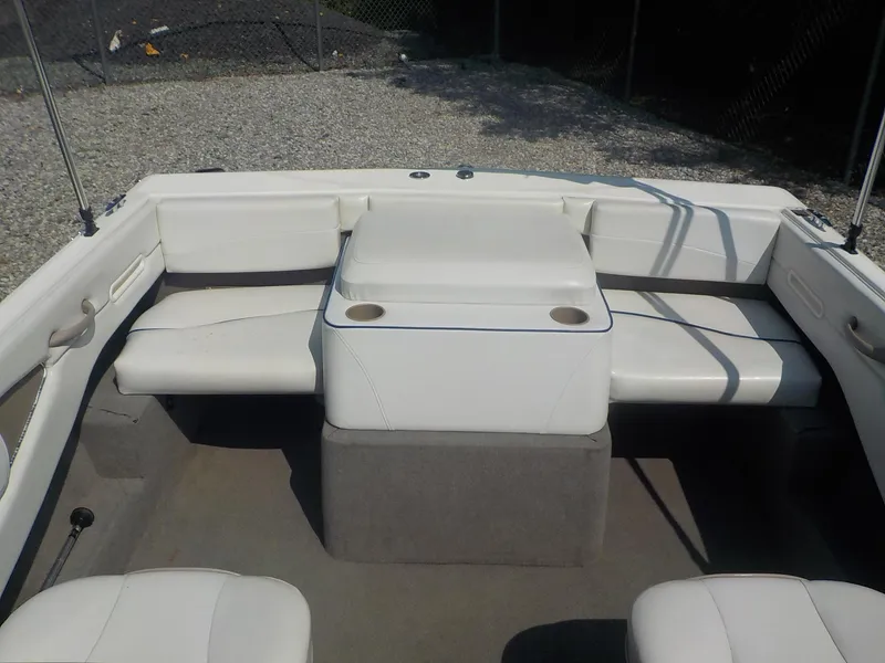 Slide: The Image of 2004 Bayliner 195 Classic boat interior with white seating and cup holders. - 19