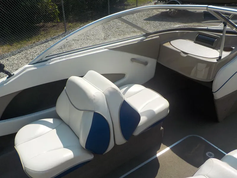 Slide: The Image of 2004 Bayliner International 195 Classic boat interior with white and blue seating. - 20
