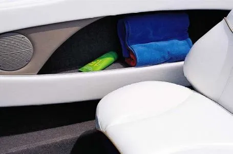 Slide: The Image of 2004 Bayliner 195 Classic interior storage with towels and sunscreen. - 3