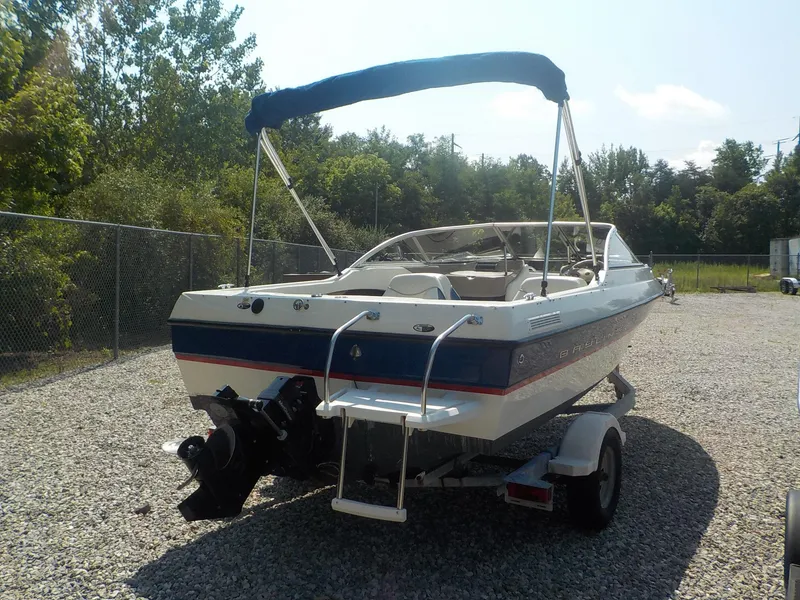 Slide: The Image of 2004 Bayliner International 195 Classic boat on trailer, parked outdoors. - 7