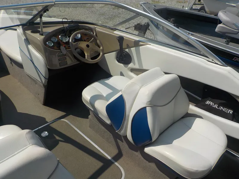 Slide: The Image of 2004 Bayliner 195 Classic boat interior with steering wheel and seating. - 8