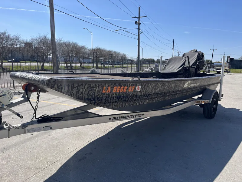 Slide: The Image of 2023 Pro-Drive SBX 1854 Stick Drive boat on trailer, parked outdoors. - 10