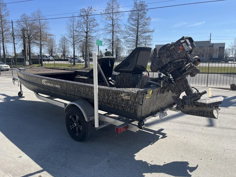 Slide: The Image of 2023 Pro-Drive SBX 1854 Stick Drive boat on trailer, outdoors in daylight. - 11