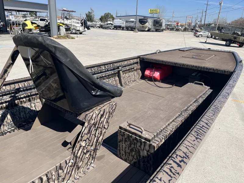 Slide: The Image of 2023 Pro-Drive SBX 1854 Stick Drive boat with camouflage design, parked outdoors. - 3