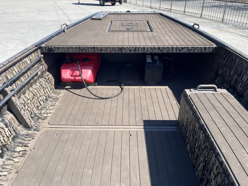 Slide: The Image of 2023 Pro-Drive SBX 1854 Stick Drive boat interior with camouflage design and storage compartments. - 7