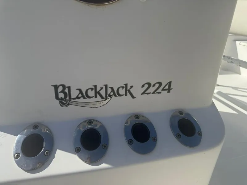 Slide: The Image of BlackJack 224 boat model, 2013, with four metallic fixtures on white surface. - 6